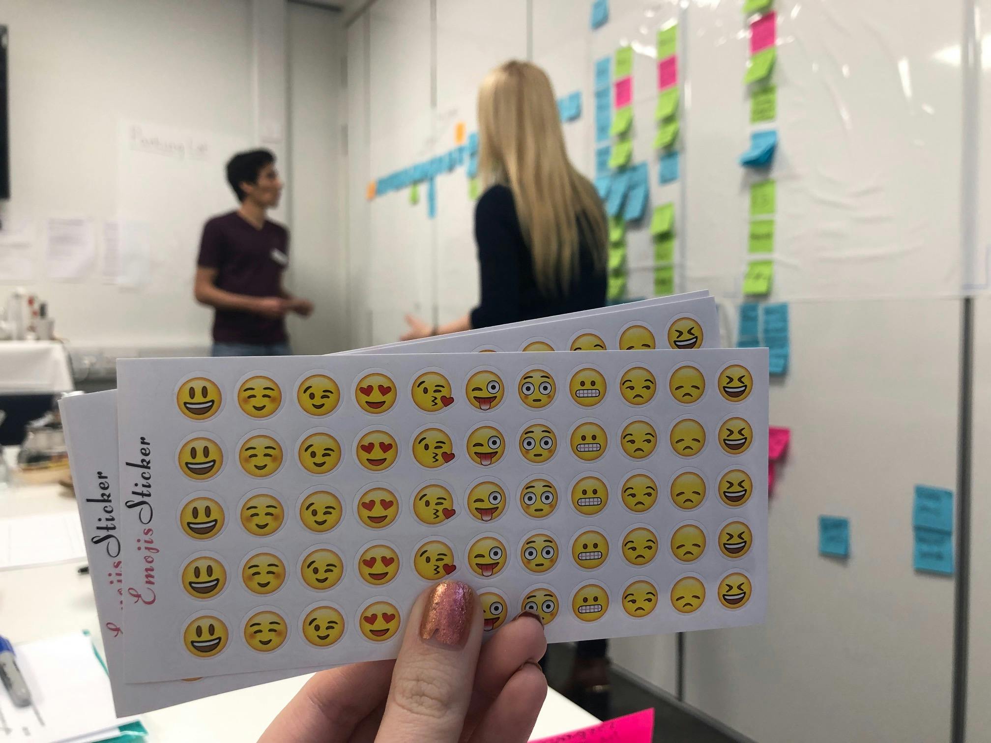 image of emoji stickers in front of someone facilitating